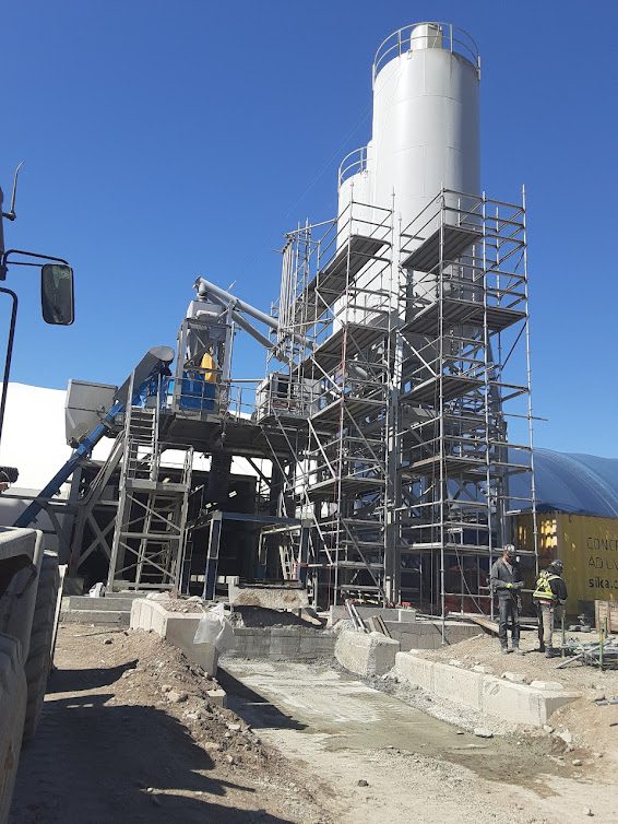 A cement plant with scaffolding around it.