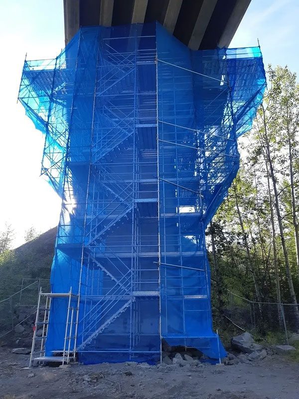 A blue tower with scaffolding around it.