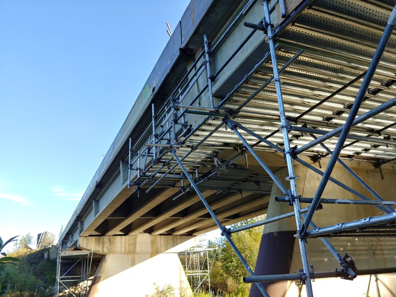 A bridge with scaffolding on it's sides.