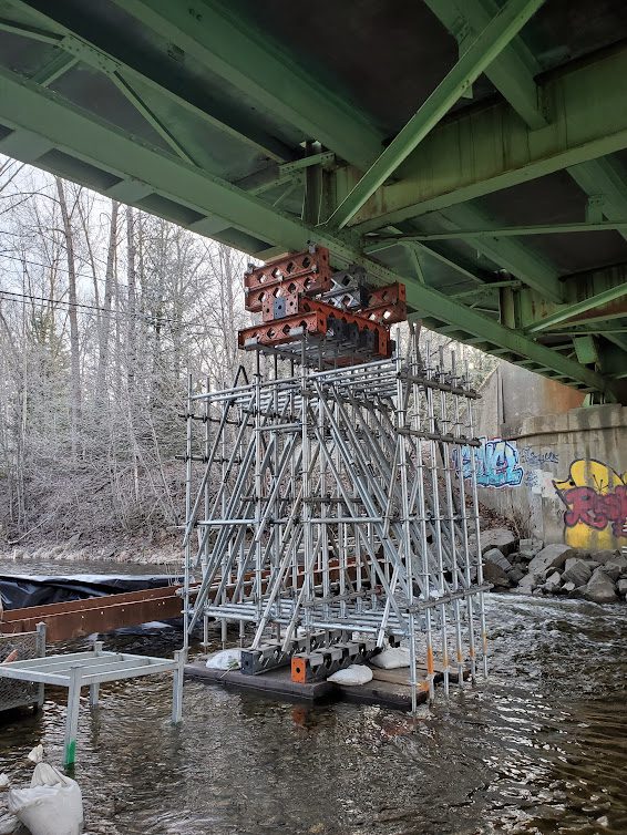 A bridge with a metal structure under it