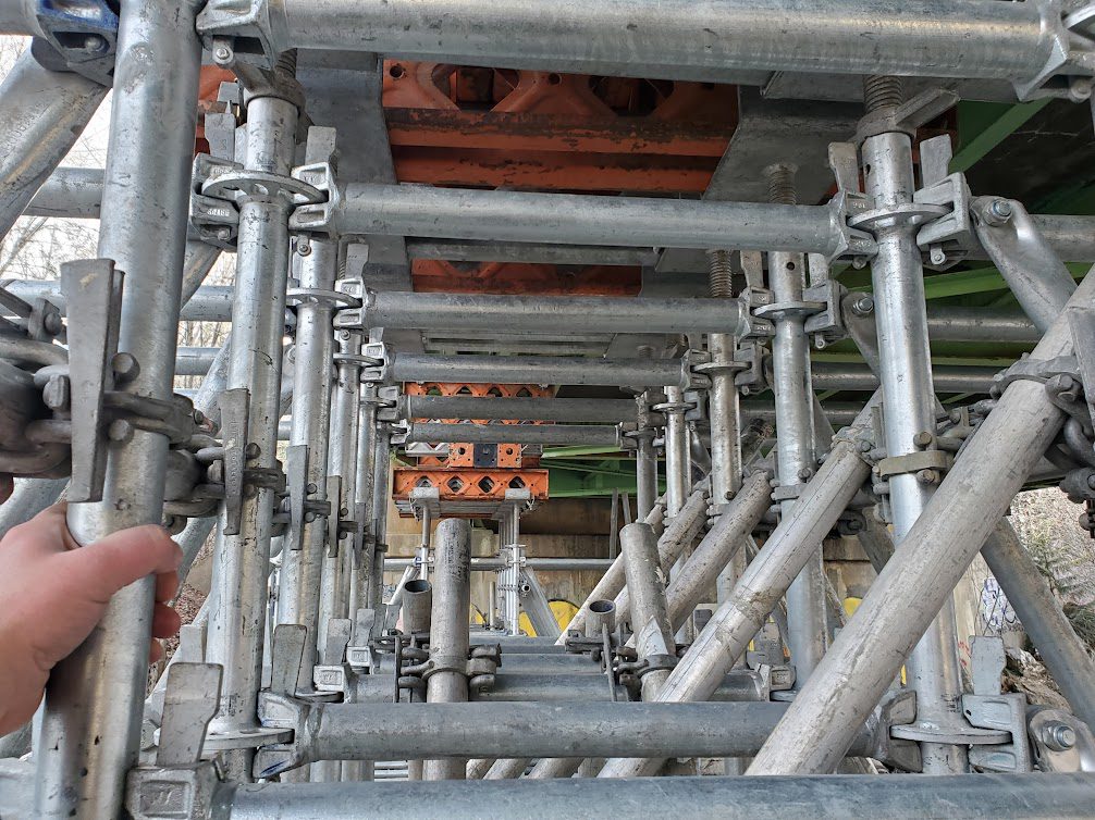 A metal structure with pipes and scaffolding.