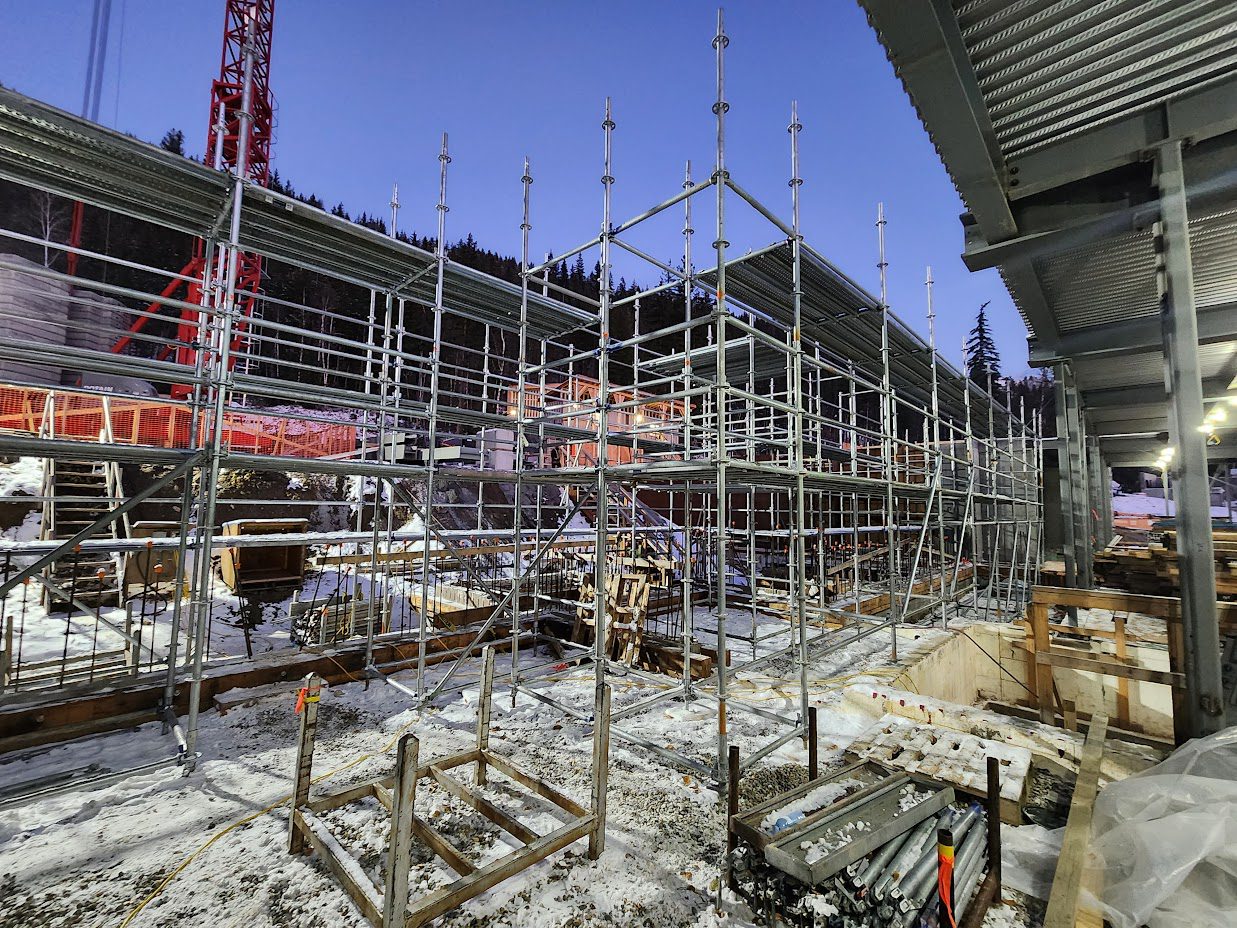 A construction site with scaffolding and machinery.